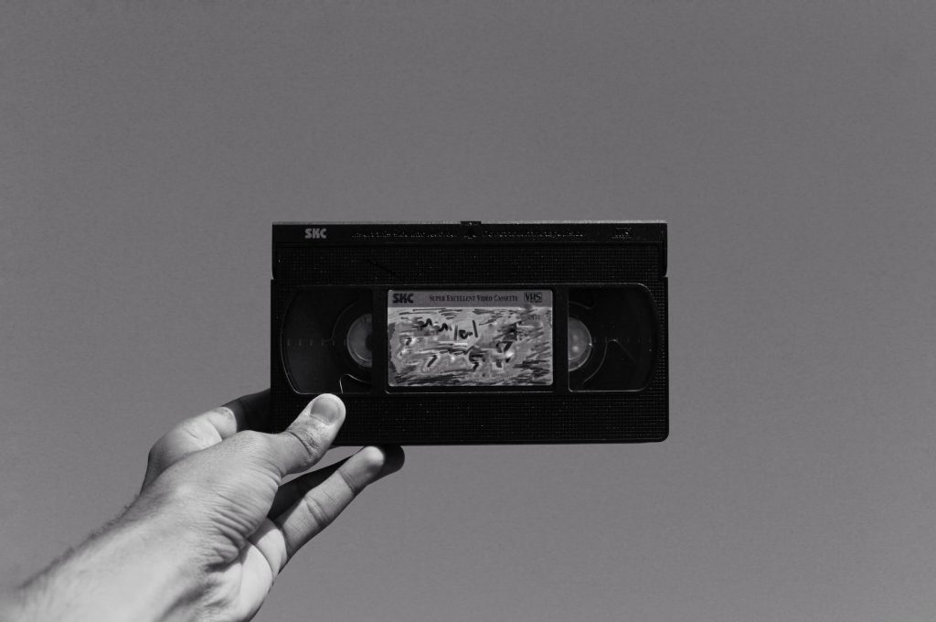 grayscale photography of vhs video cassette